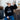 Teen-aged Boy sitting with cowboy hat on wearing black crewneck with the Royal Family Farms Crown Logo