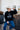 Teen-aged Boy sitting with cowboy hat on wearing black crewneck with the Royal Family Farms Crown Logo
